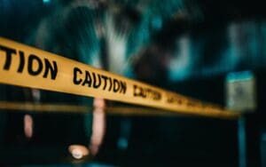 Yellow caution tape blocking access in a dark, possibly restricted area, symbolizing risks to Japan technology or copyright law without proper innovation.