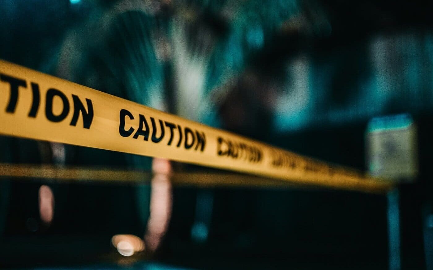 Yellow caution tape blocking access in a dark, possibly restricted area, symbolizing risks to Japan technology or copyright law without proper innovation.